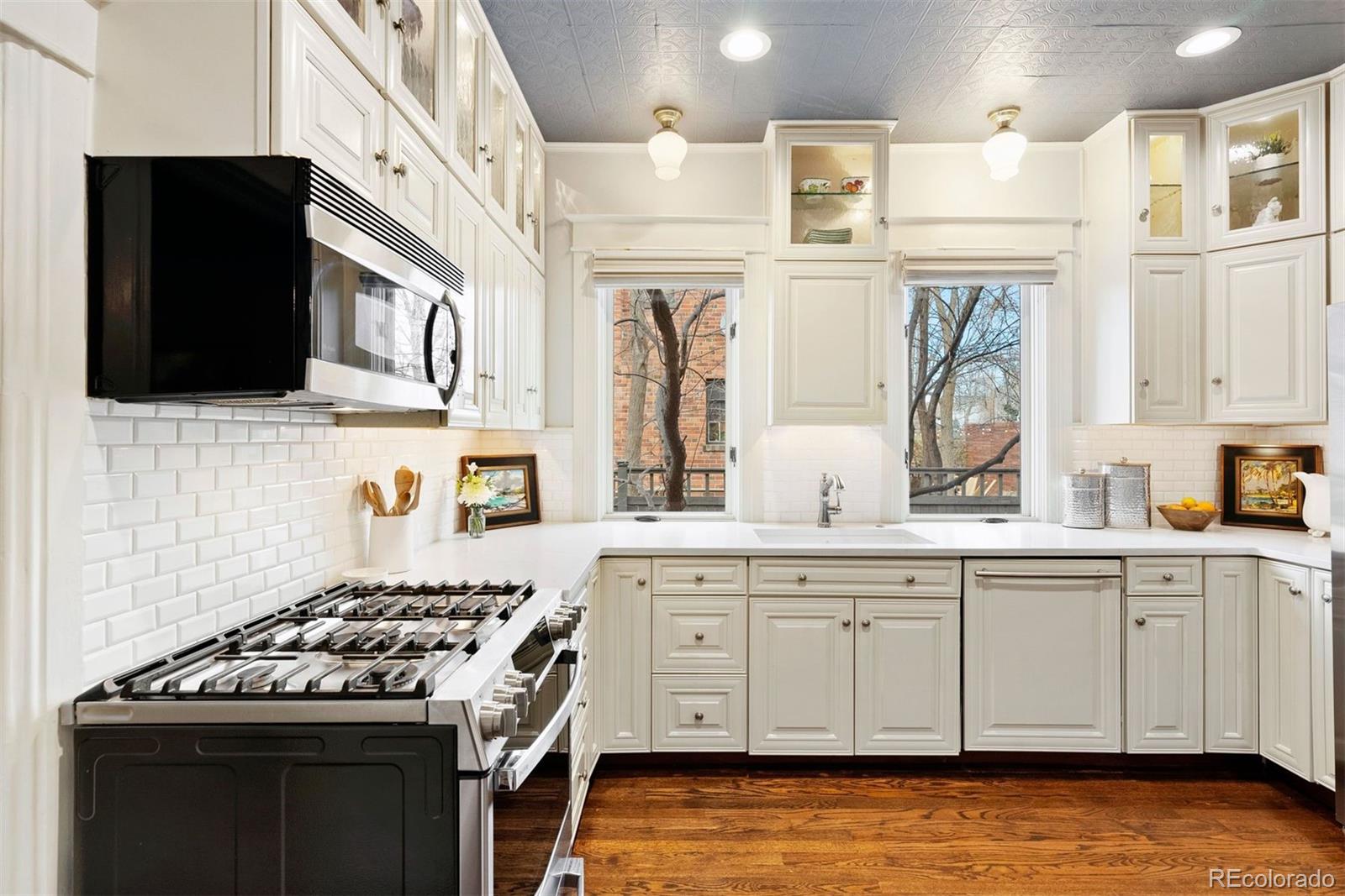 1324 South University Boulevard Denver, CO 80210 - Photo 22 of 47 a kitchen with stainless steel appliances granite countertop a stove and a sink