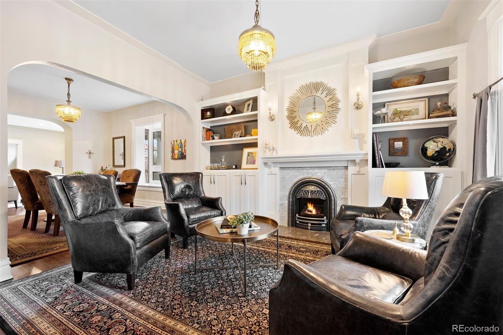 1324 South University Boulevard Denver, CO 80210 - Photo 25 of 47 a living room with furniture and a fireplace