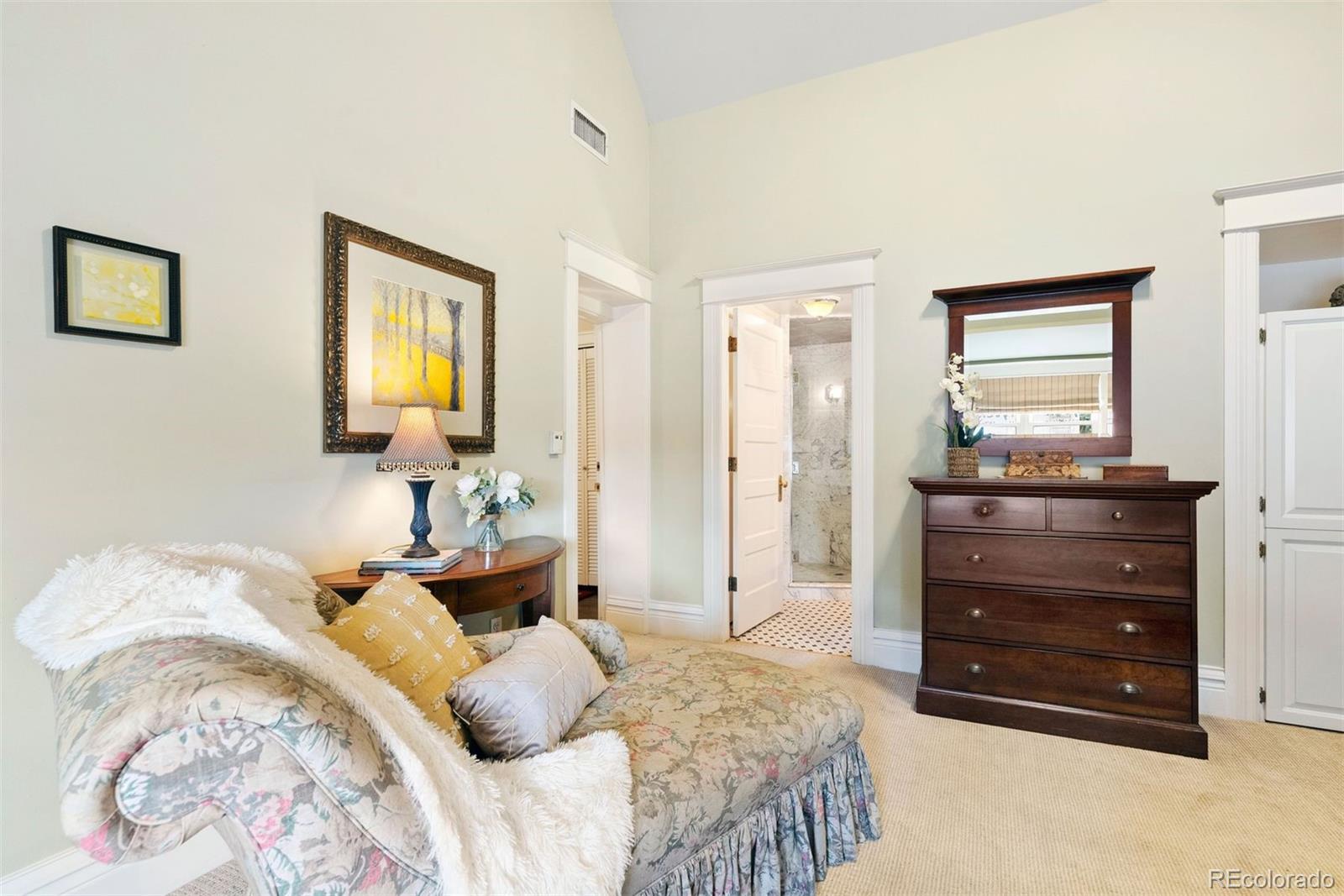 1324 South University Boulevard Denver, CO 80210 - Photo 32 of 47 a bedroom with a bed and a mirror