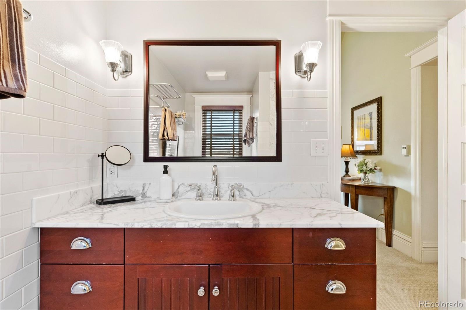 1324 South University Boulevard Denver, CO 80210 - Photo 33 of 47 a bathroom with a sink and a mirror