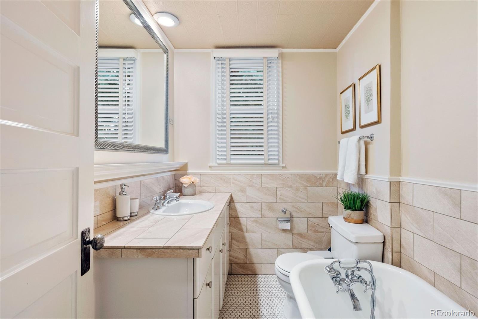 1324 South University Boulevard Denver, CO 80210 - Photo 36 of 47 a bathroom with a sink and a toilet