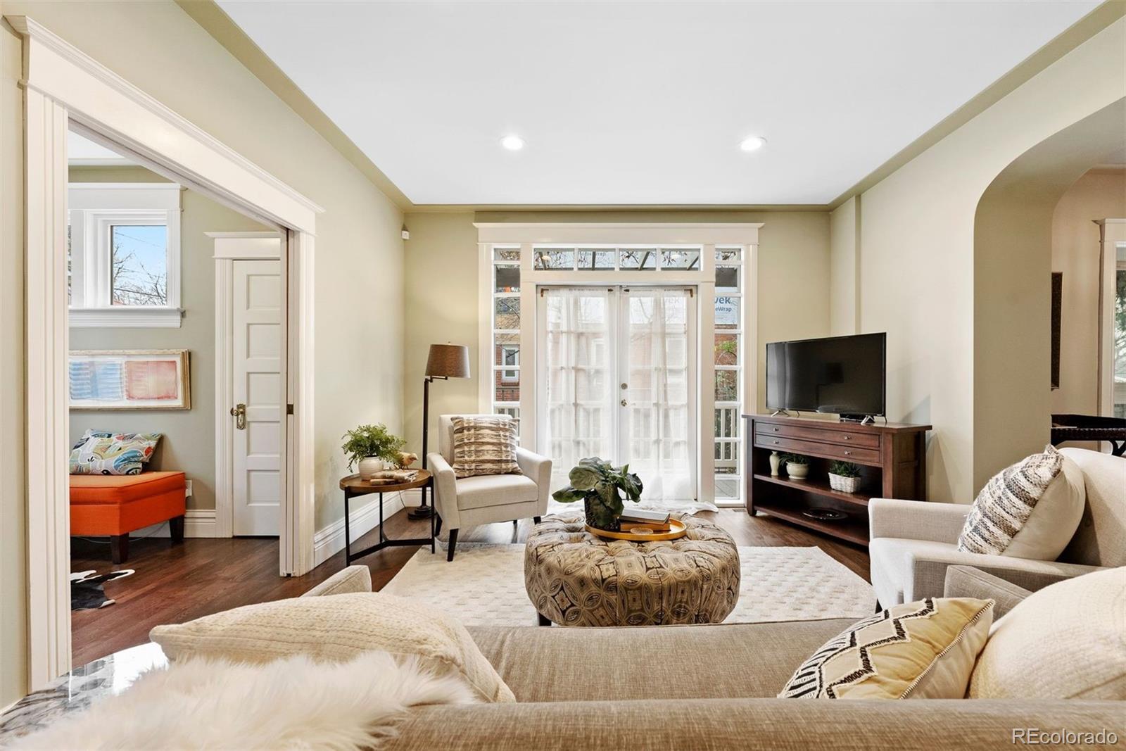 1324 South University Boulevard Denver, CO 80210 - Photo 7 of 47 a living room with furniture and a flat screen tv