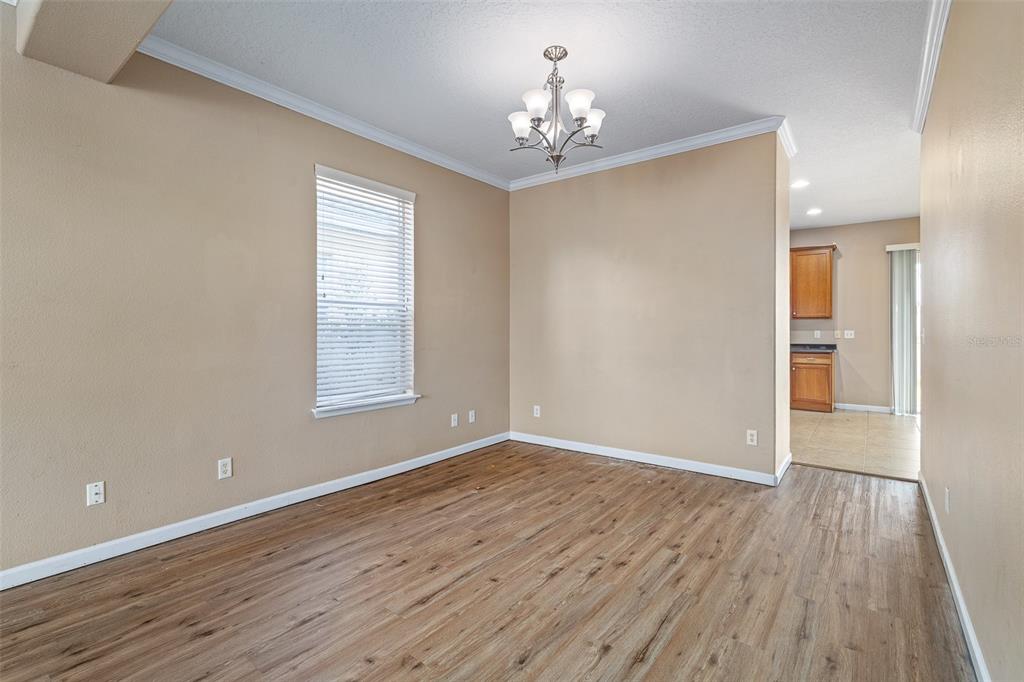 1929 Cove Point Road Port Orange, FL 32128 - Photo 11 of 45 wooden floor in an empty room with a window