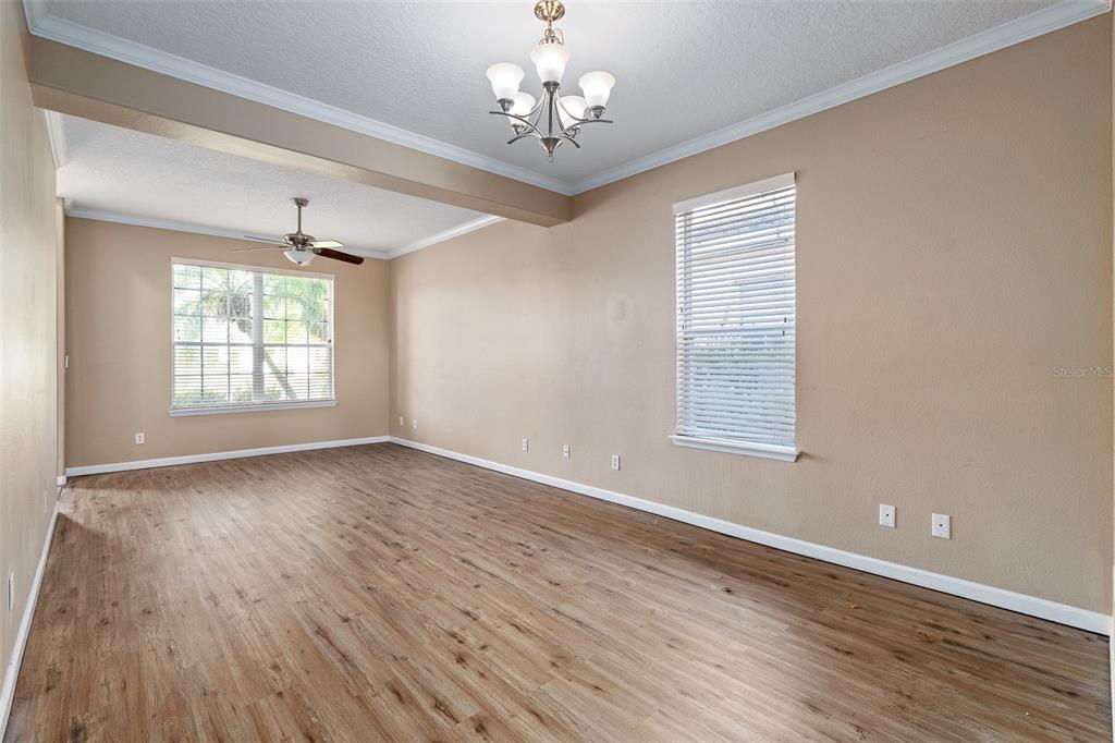 1929 Cove Point Road Port Orange, FL 32128 - Photo 12 of 45 a view of an empty room with wooden floor and a window