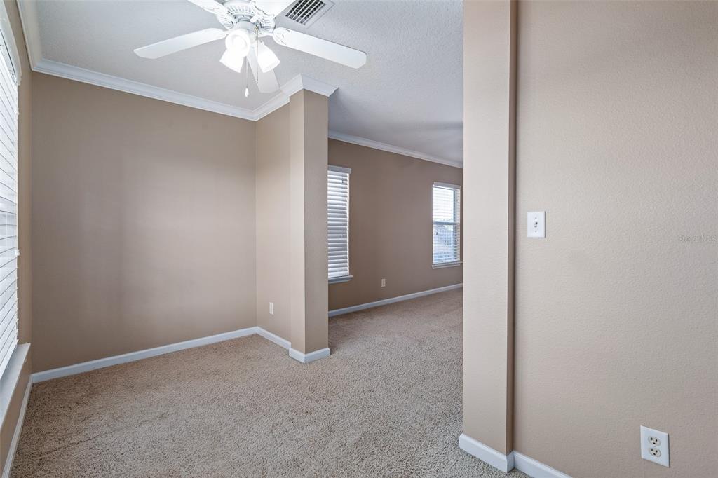 1929 Cove Point Road Port Orange, FL 32128 - Photo 19 of 45 a view of an empty room with a chandelier fan