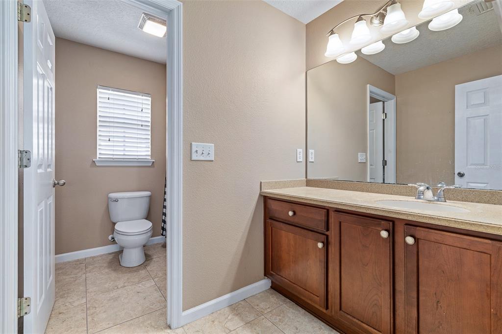 1929 Cove Point Road Port Orange, FL 32128 - Photo 27 of 45 a bathroom with a double vanity sink and a toilet