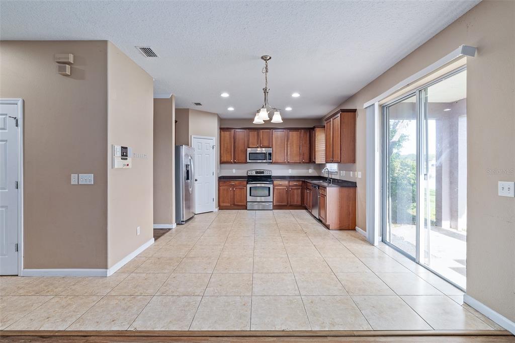 1929 Cove Point Road Port Orange, FL 32128 - Photo 3 of 45 a open kitchen with stainless steel appliances granite countertop a refrigerator and a sink