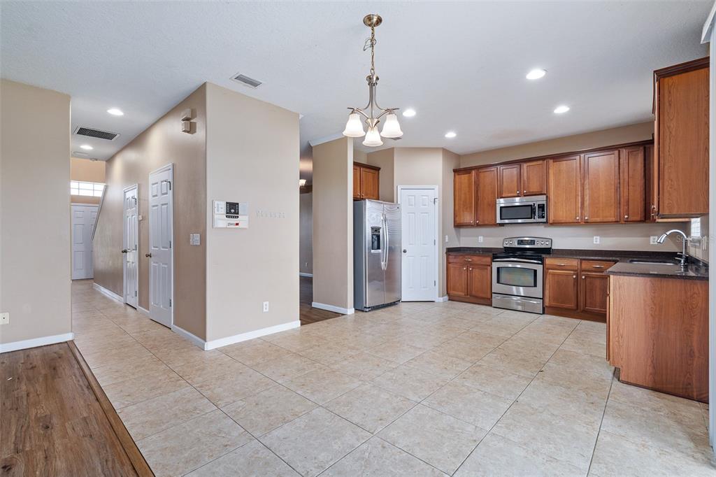 1929 Cove Point Road Port Orange, FL 32128 - Photo 6 of 45 a kitchen with stainless steel appliances granite countertop a refrigerator a oven a sink and a oven