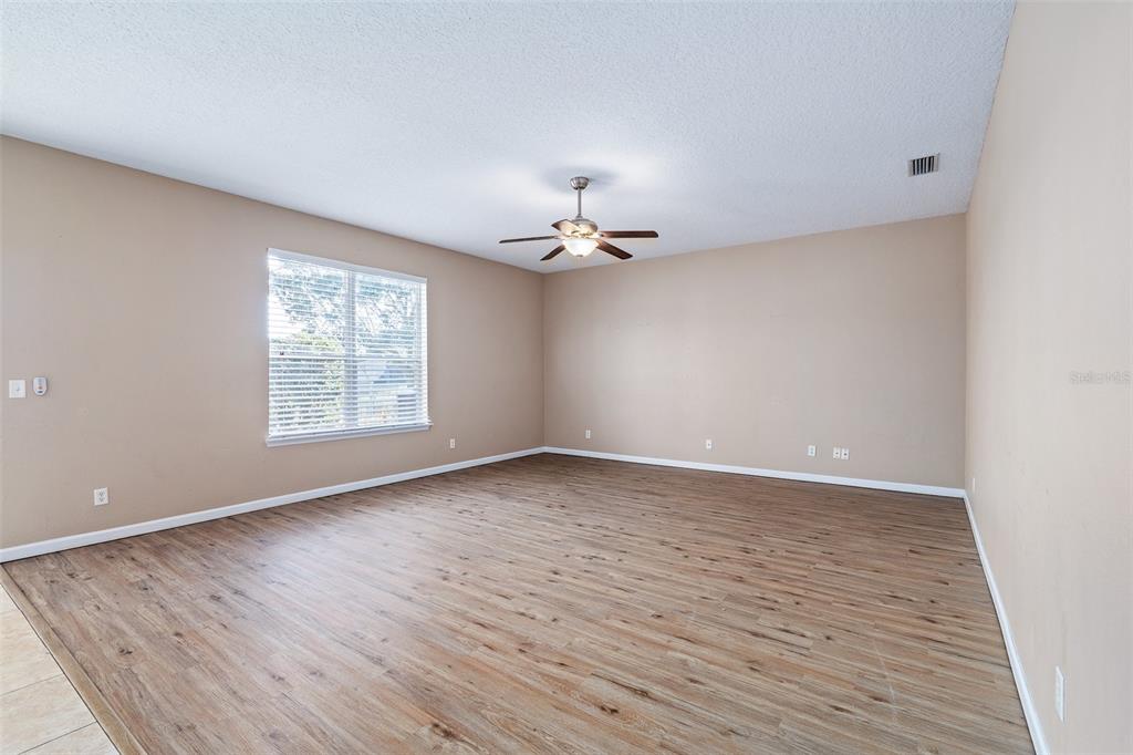 1929 Cove Point Road Port Orange, FL 32128 - Photo 8 of 45 wooden floor in an empty room with a window