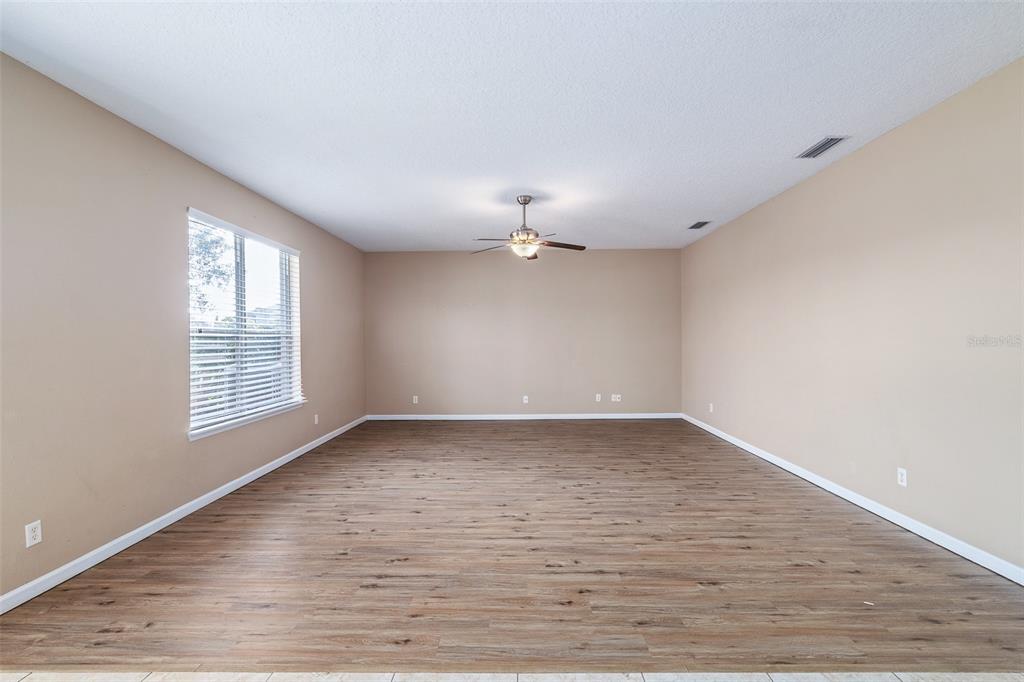 1929 Cove Point Road Port Orange, FL 32128 - Photo 9 of 45 a view of an empty room with wooden floor and a window
