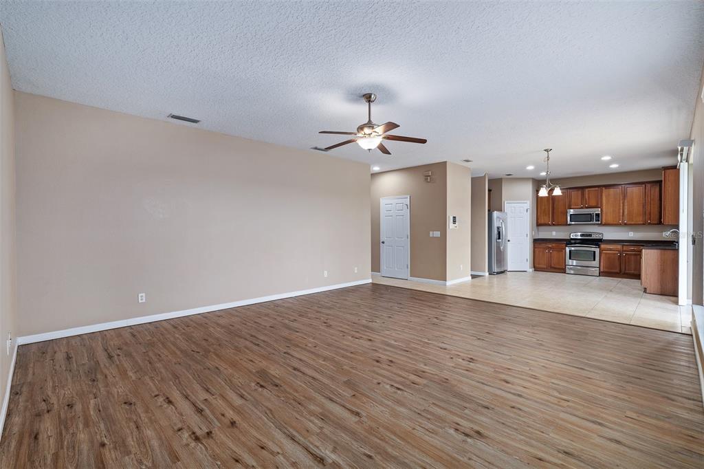 1929 Cove Point Road Port Orange, FL 32128 - Photo 10 of 45 a view of a kitchen with a dishwasher a kitchen wooden floor and a ceiling fan
