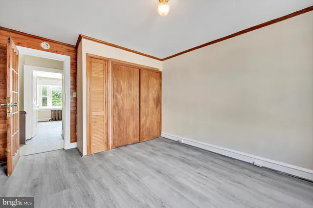a view of an empty room with wooden floor
