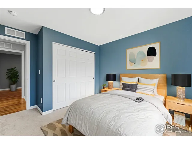 a bedroom with a bed and lamp