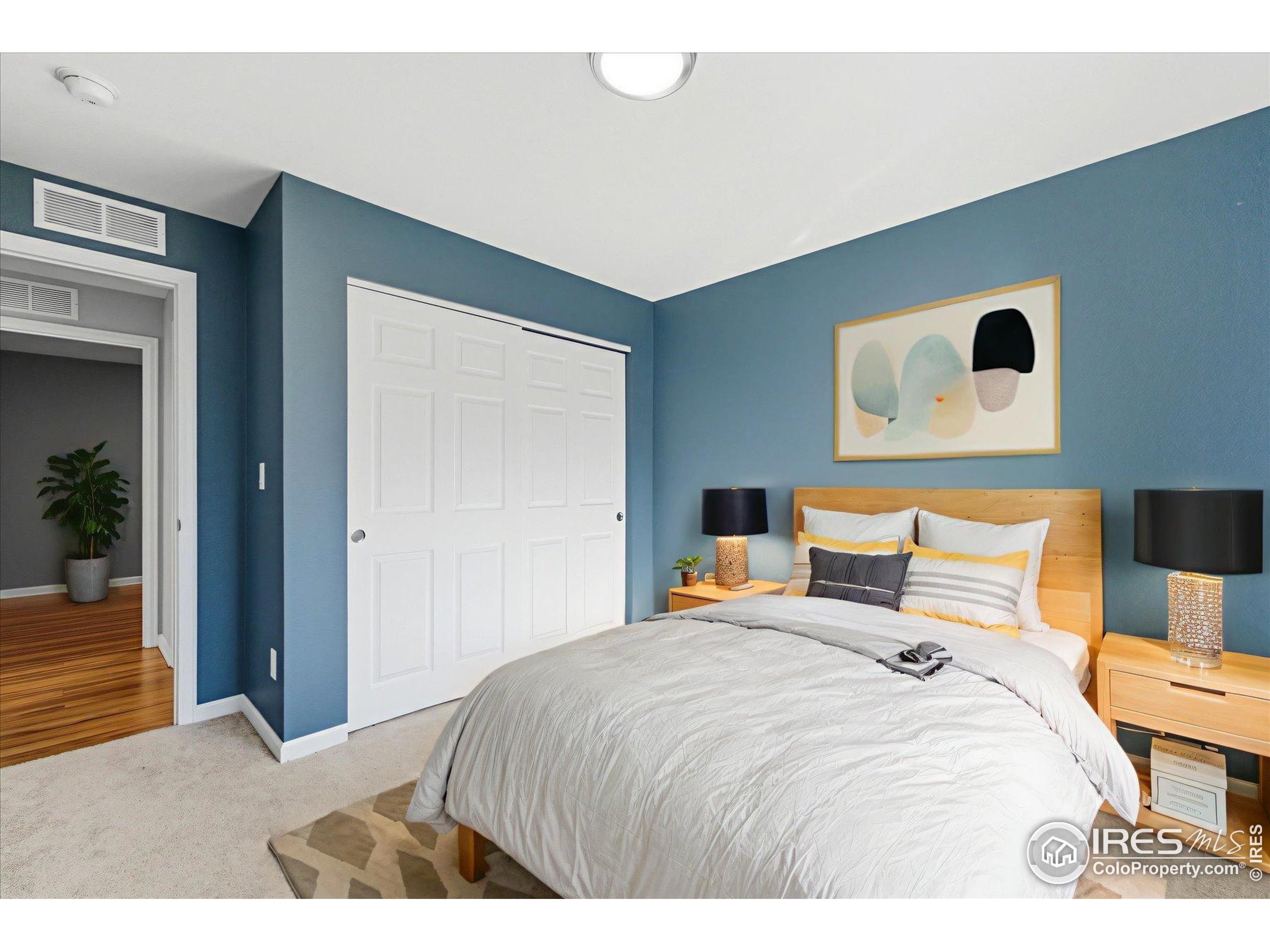 1812 Rice Street Longmont, CO 80501 - Photo 18 of 44 a bedroom with a bed and lamp