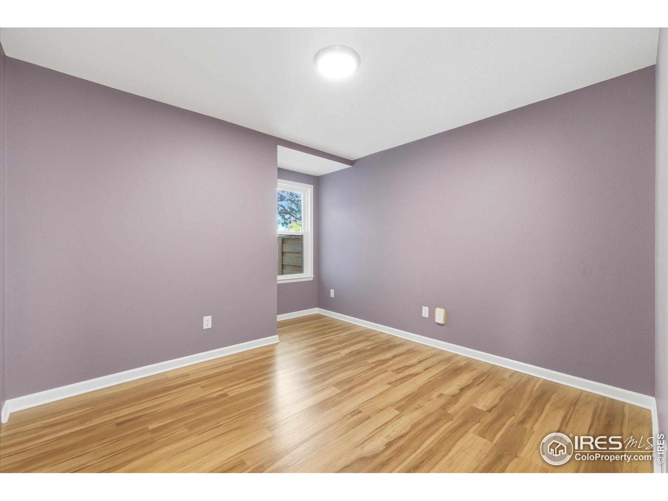 1812 Rice Street Longmont, CO 80501 - Photo 22 of 44 a view of an empty room with window and wooden floor