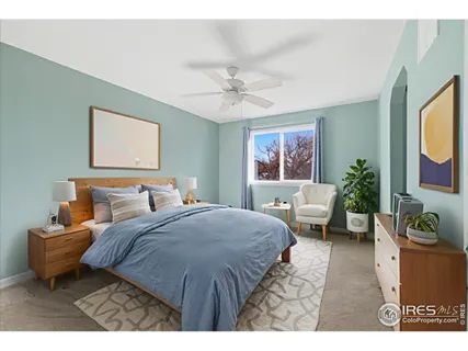 a bedroom with a bed a couch and potted plant