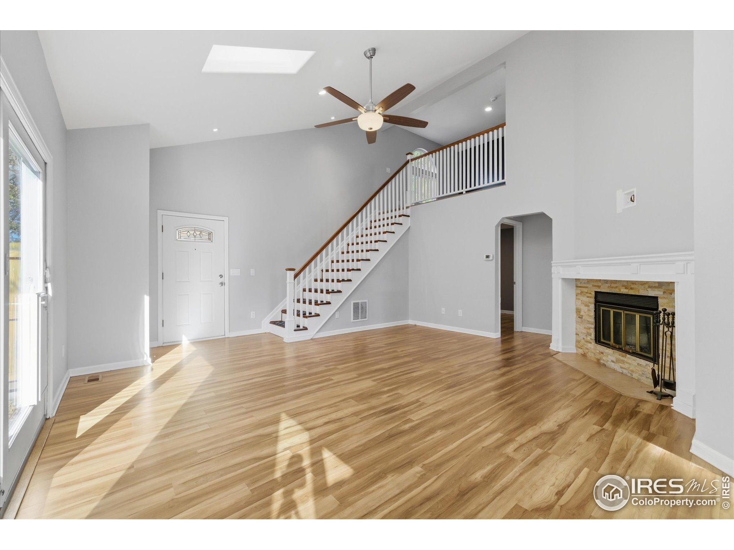 1812 Rice Street Longmont, CO 80501 - Photo 7 of 44 a view of empty room with fireplace and wooden floor