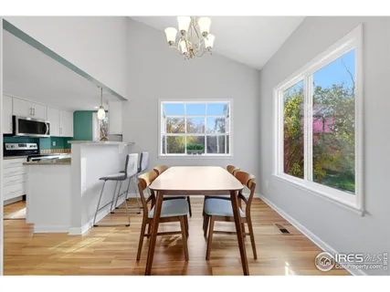 a dining room with furniture a window and a chandelier