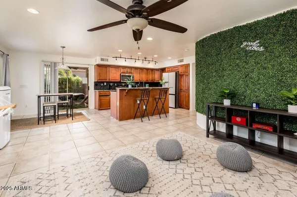 a kitchen with stainless steel appliances kitchen island granite countertop a dining table and chairs