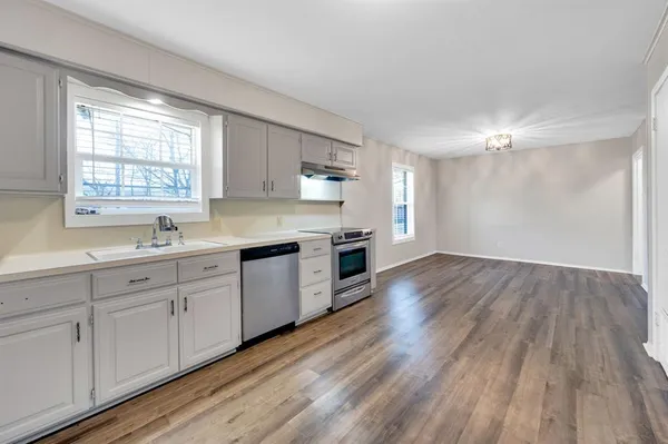 a kitchen with sink cabinets and window