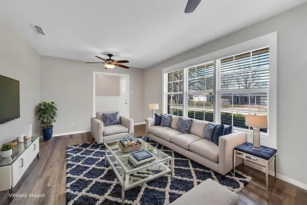 a living room with furniture and a large window