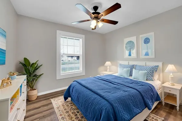 a view of a big room with wooden floor and windows