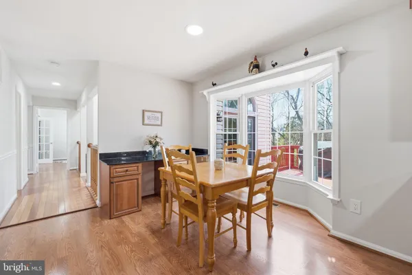 a bedroom with a bed chandelier and a window