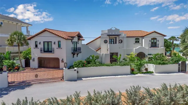 a front view of a house with a yard and a garden