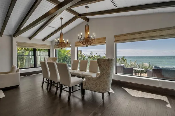 a kitchen with stainless steel appliances granite countertop a table chairs sink and cabinets