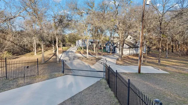 an aerial view of house with yard and mountain view in back