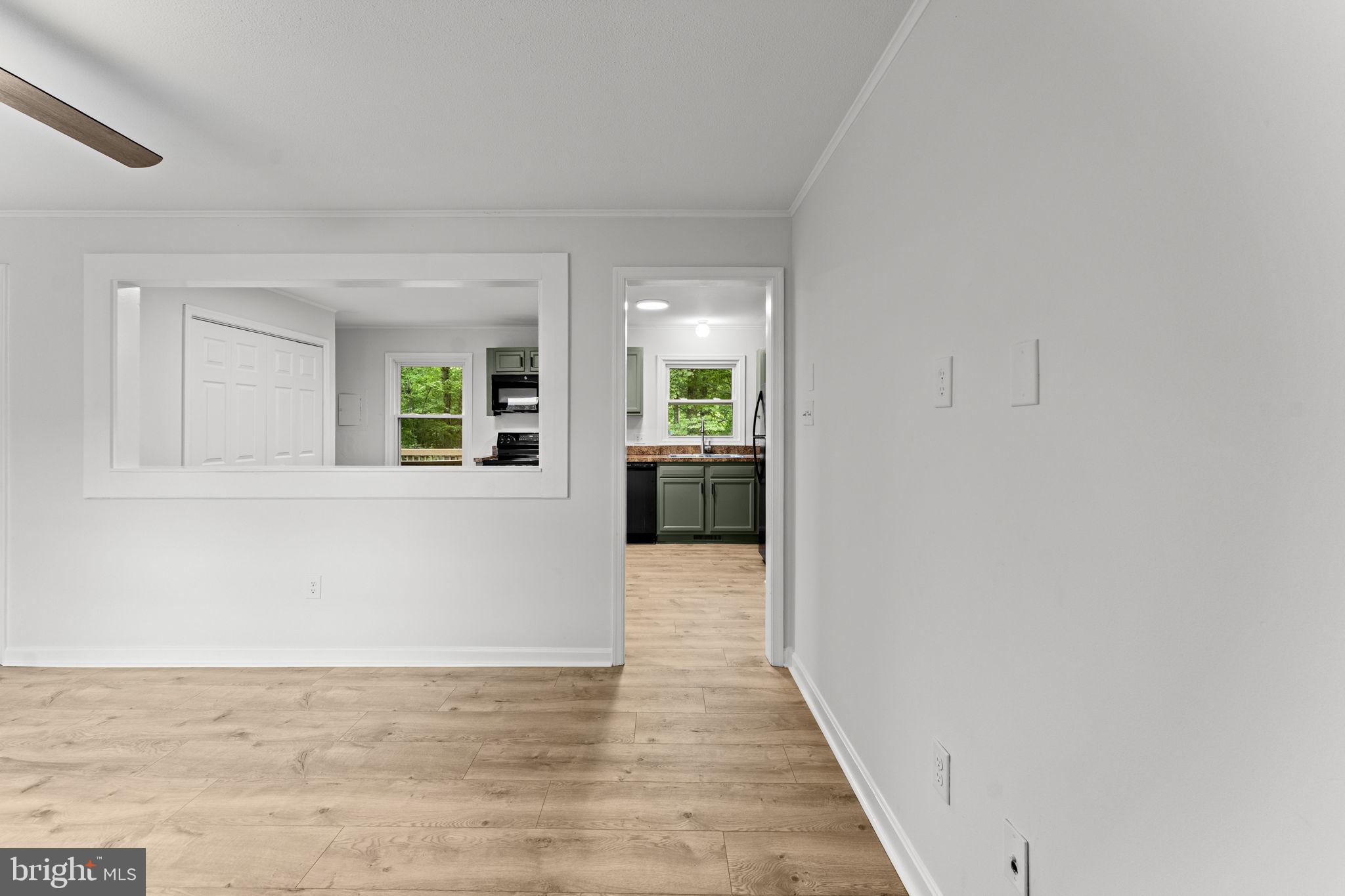 1821 James City Road Reva, VA 22735 - Photo 6 of 44 a view of a hallway with wooden floor and a living room