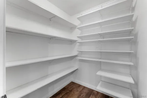 a view of walk in closet with empty racks