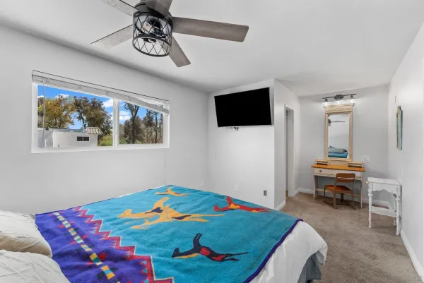 a bedroom with furniture and a window