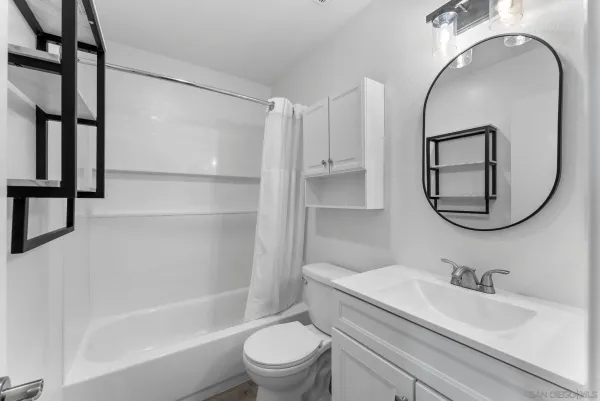 a bathroom with a sink toilet and a mirror