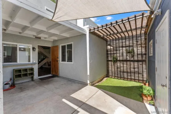 a view of an empty room with a fireplace and a window