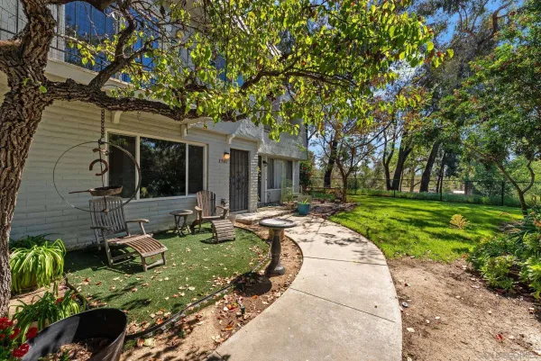 a backyard of a house with outdoor seating