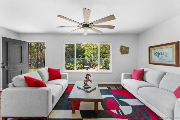a living room with furniture and a large window