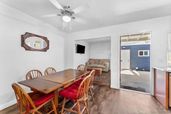 a view of a dining room with furniture and a chandelier