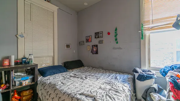 a bedroom with a bed and a window
