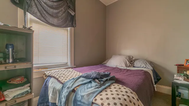 a bedroom with a bed and a television