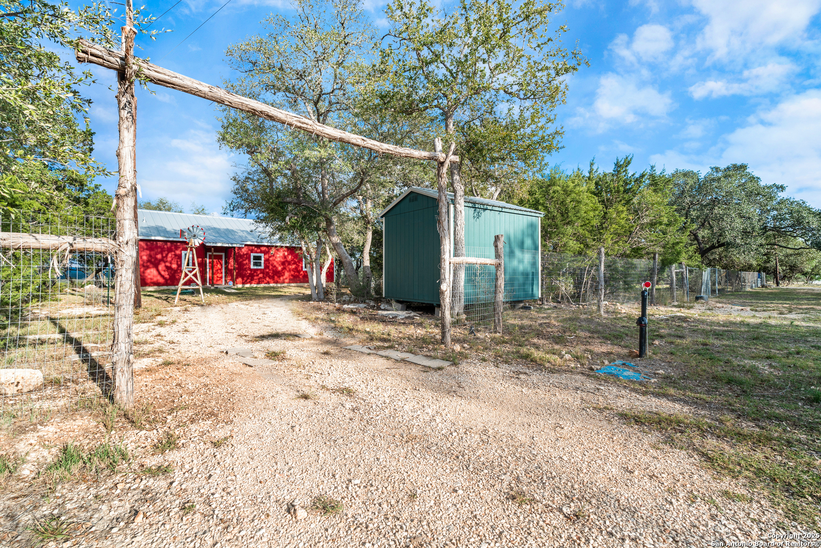 1110 Grandview Circle Bandera, TX 78003 - Photo 1 of 45 a view of a white house with a small yard and large tree