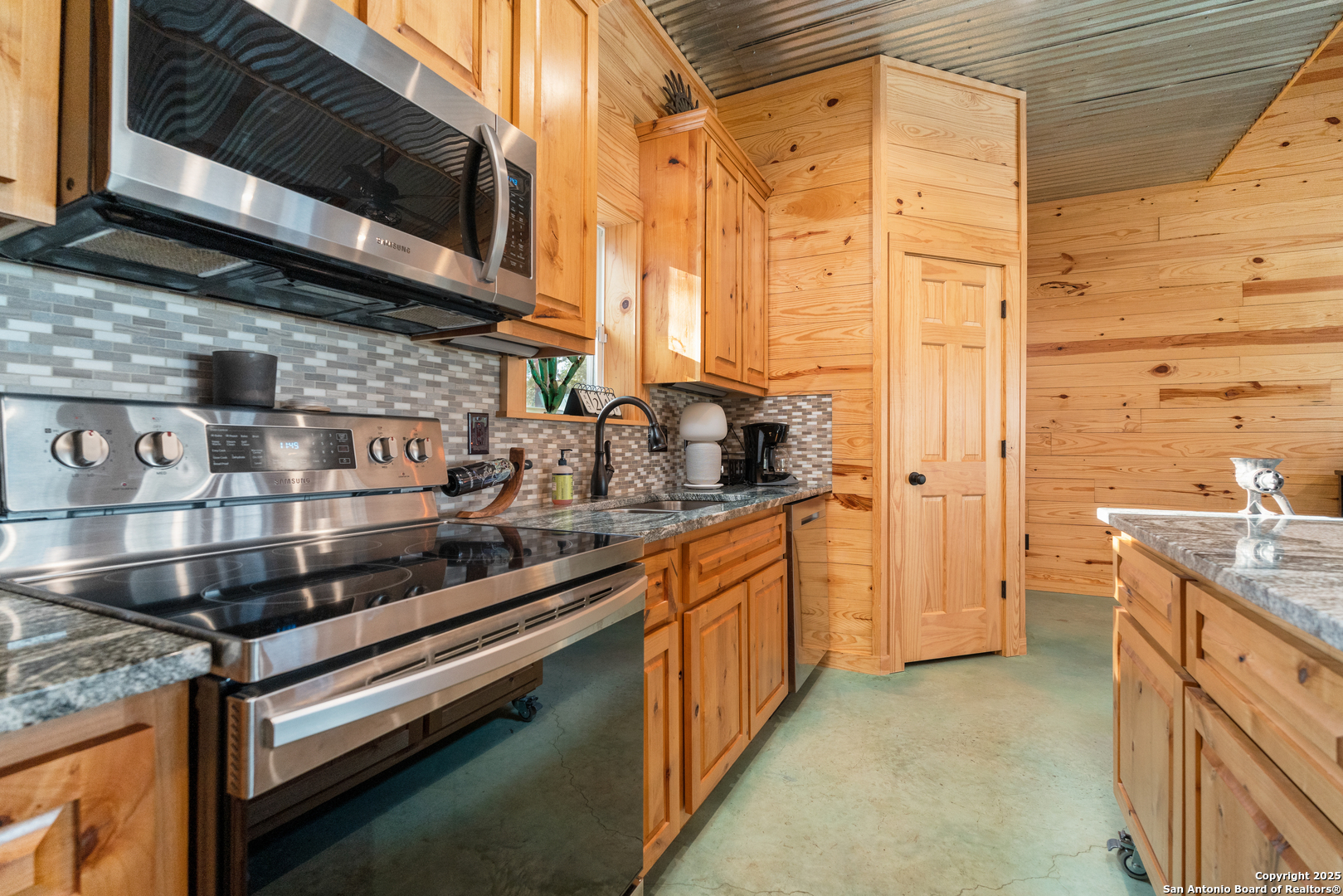 1110 Grandview Circle Bandera, TX 78003 - Photo 13 of 45 a kitchen with stainless steel appliances a sink a stove and a microwave