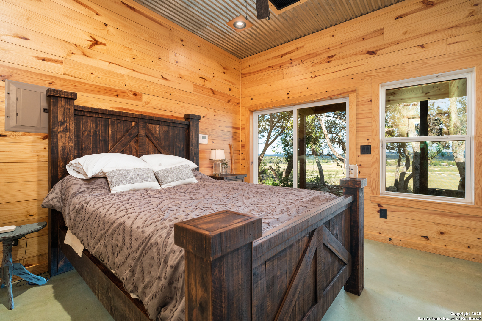 1110 Grandview Circle Bandera, TX 78003 - Photo 21 of 45 a bedroom with a bed and a large window with the outer view