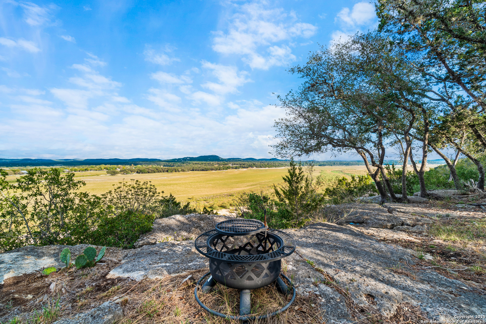 1110 Grandview Circle Bandera, TX 78003 - Photo 24 of 45 a view of a patio with a table and chairs under an umbrella