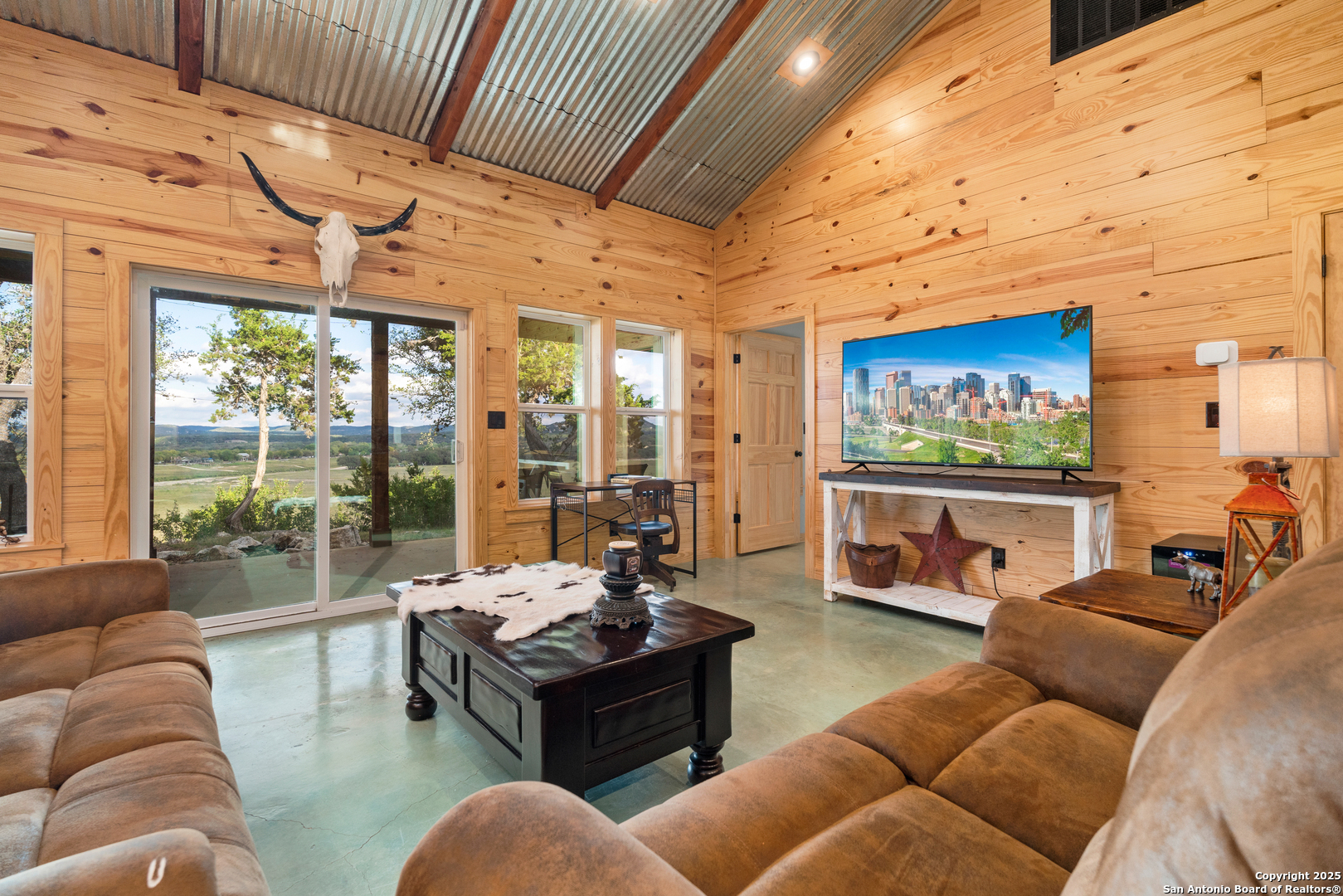 1110 Grandview Circle Bandera, TX 78003 - Photo 8 of 45 a living room with furniture a floor to ceiling window and a flat screen tv