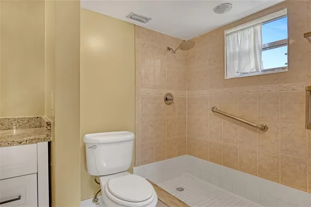 a bathroom with a toilet and a shower