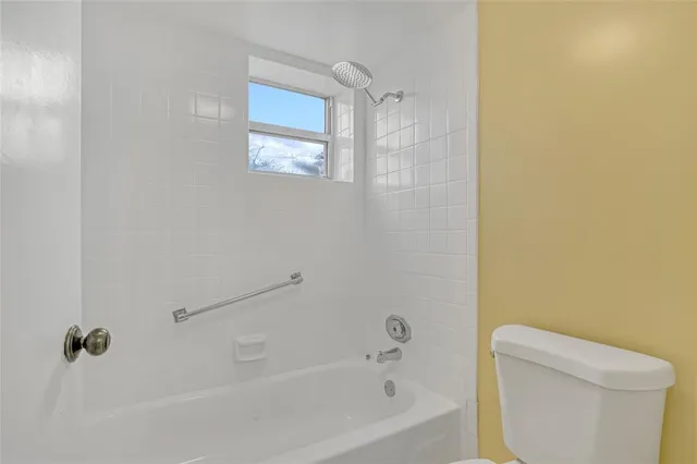 a white bath tub sitting next to a white toilet
