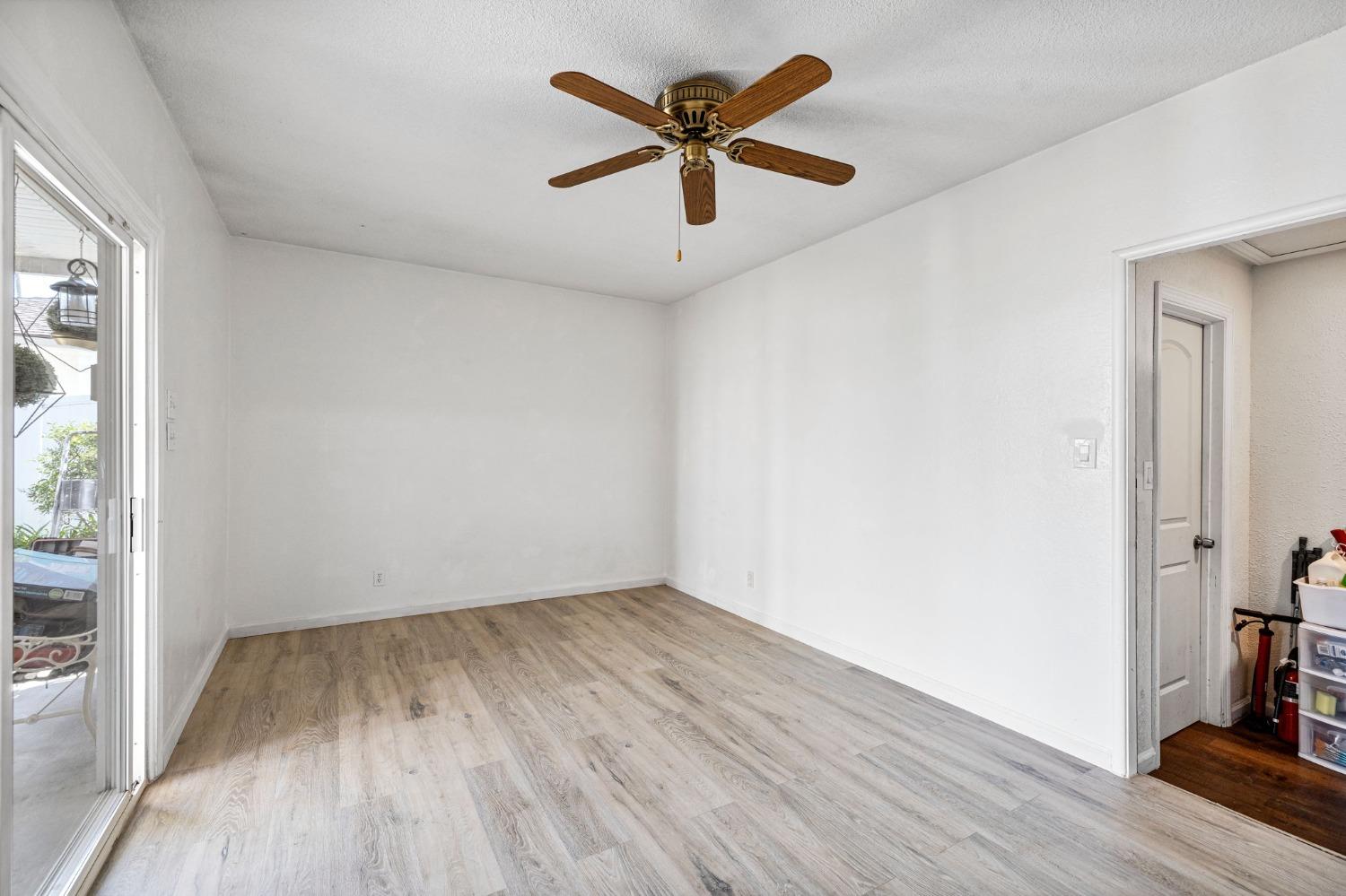 1345 Peach Avenue Clovis, CA 93612 - Photo 12 of 27 an empty room with wooden floor and windows
