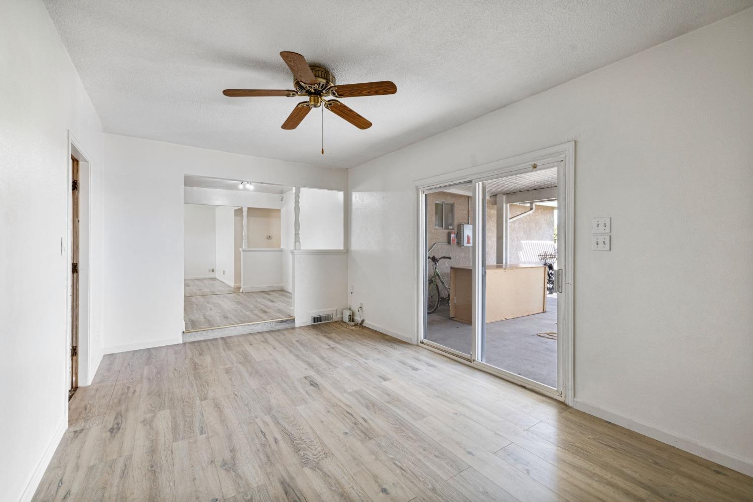 1345 Peach Avenue Clovis, CA 93612 - Photo 13 of 27 a view of empty room with wooden floor and ceiling fan