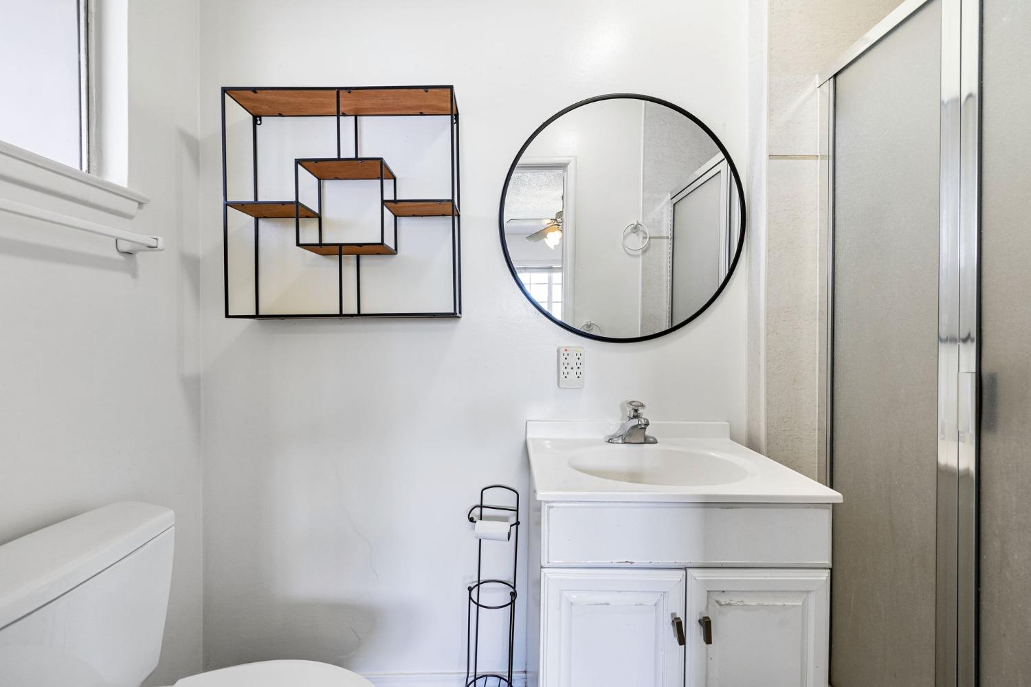 1345 Peach Avenue Clovis, CA 93612 - Photo 19 of 27 a bathroom with a toilet a sink and a mirror